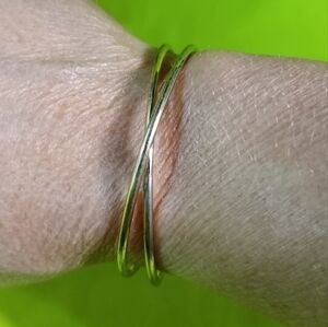 Goldtone wire crossed Cuff bracelet shows some wear